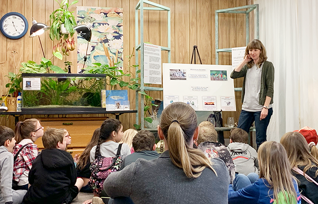 Natalie Case leading a 4th-grade class tour.