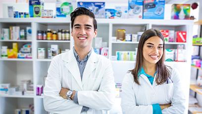 pharmacy technicians working behind the counter in a pharmacy