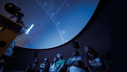 Students observing a presentation in the SCC Planetarium