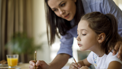 A mother helping her daughter with homework.