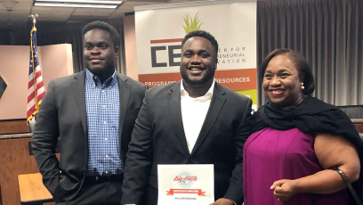 A photo of Wilson Okwuobu as he poses with his award beside his family.