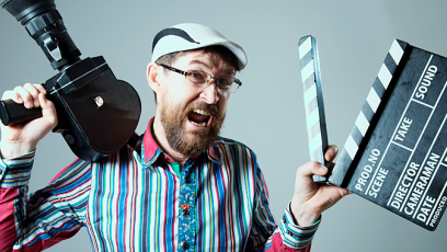 man holding camera and clapboard