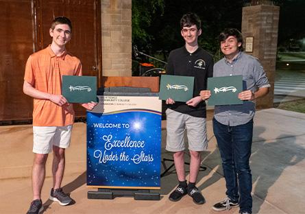 Excellence Under the Stars - student posing with awards