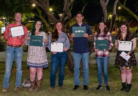 Students posing with awards