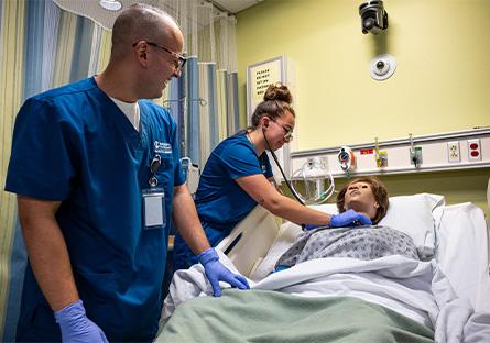 nursing students administering to robotic patient