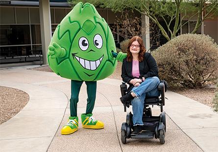 Artie the Artichoke Mascot with an SCC student in a wheelchair
