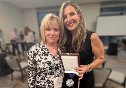 Dr. Stephanie Polliard and Voula Popovich display award