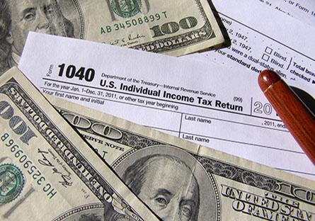 Dollar bills and Tax forms 