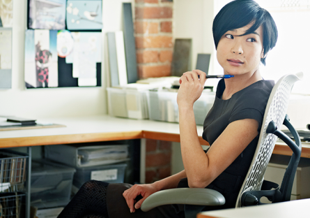 student at desk with laptop and notepad