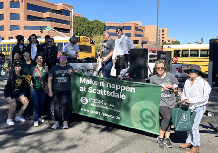 parada del sol parade with mascot and students