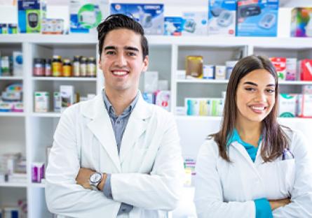 pharmacy technicians working behind the counter in a pharmacy