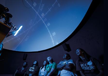 Students observing a presentation in the SCC Planetarium