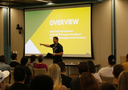 A lecturer in an auditorium introducing new students to SCC.