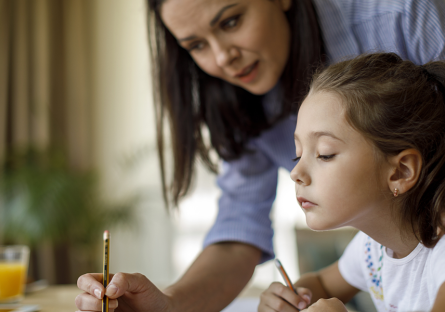 A mother helping her daughter with homework.