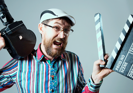 man holding camera and clapboard