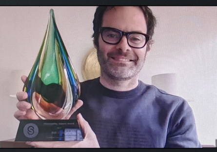 Bill Hader holding outstanding alumni award