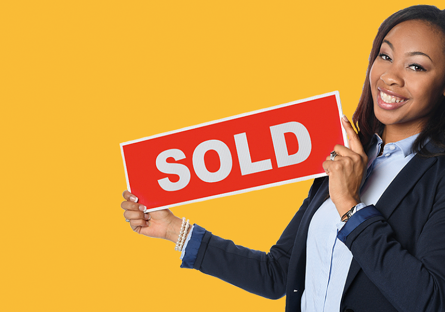 Realtor holding SOLD sign