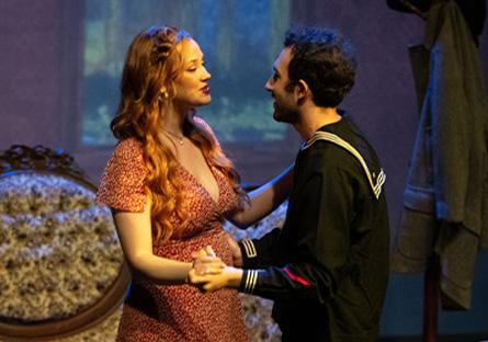 two students dancing onstage in a victorian setting