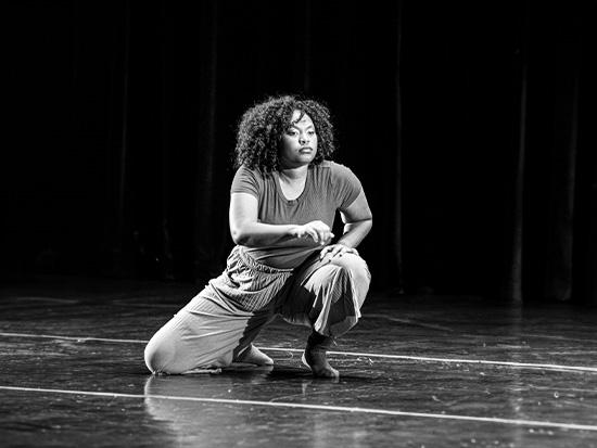 dancer kneeling on stage