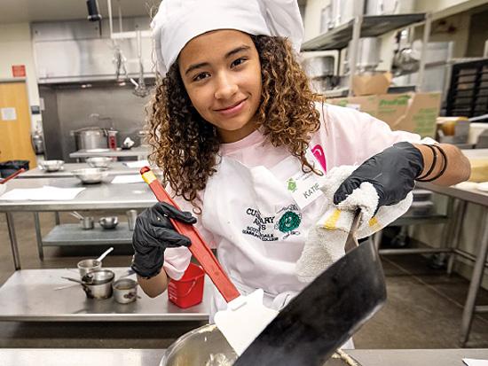 junior chef cooking in kitchen