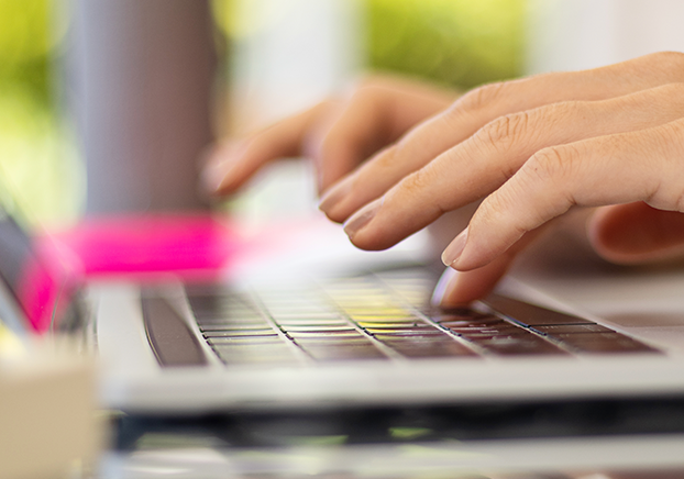 fingers typing on a keyboard