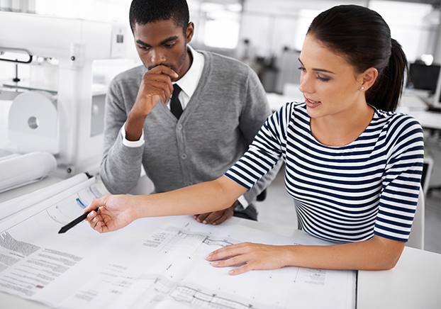 two people looking at architectural plans