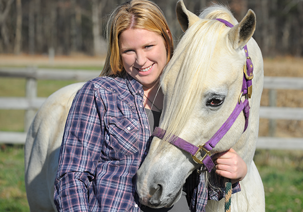student hugging horse