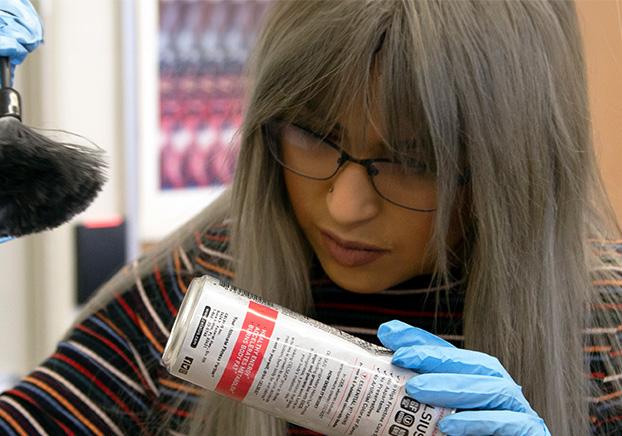 forensic scientist dusting for fingerprints