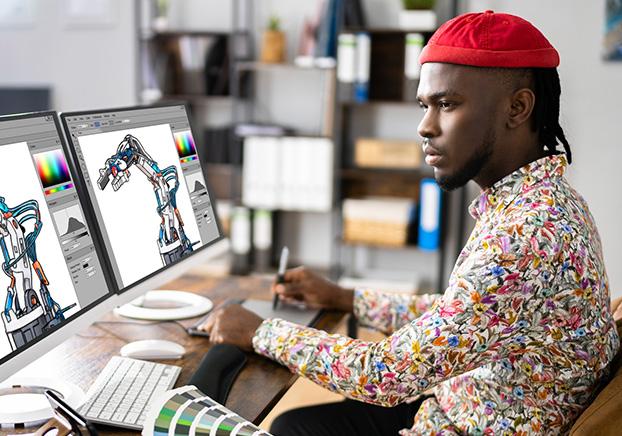 designer with color guide working at a computer