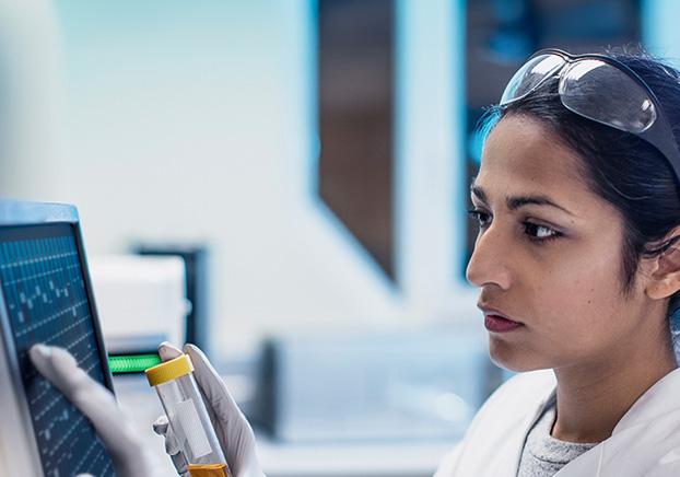 scientist analyzing tube contents