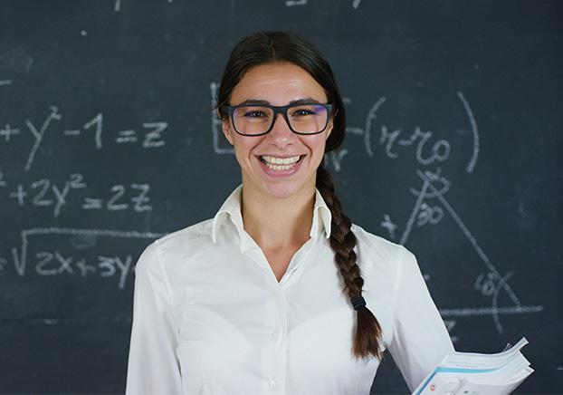 student with math problem on chalkboard