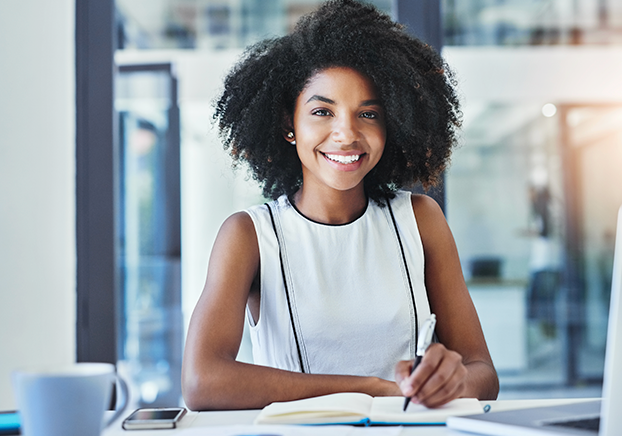 smiling student working at  a desk