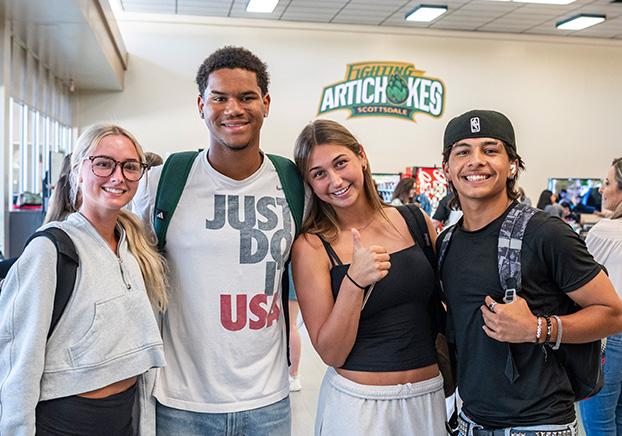 group of four students attending an event