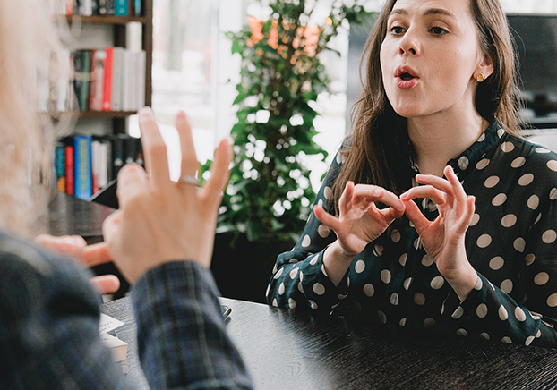 two people using sign language to communicate