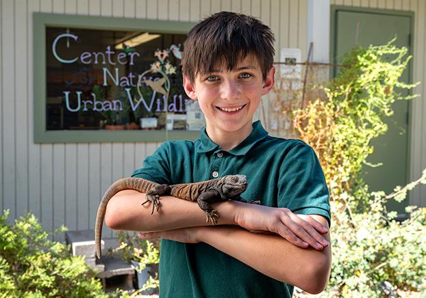 kid holding reptile