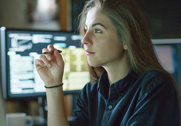 female staring at a computer screen