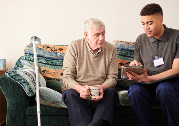 community health worker assisting elderly man