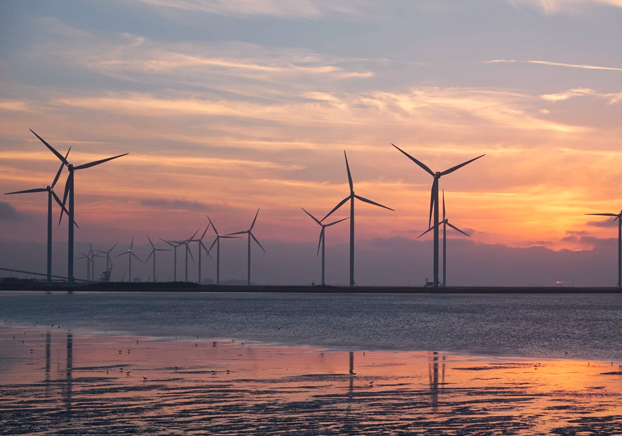 wind powered generators with sunset background