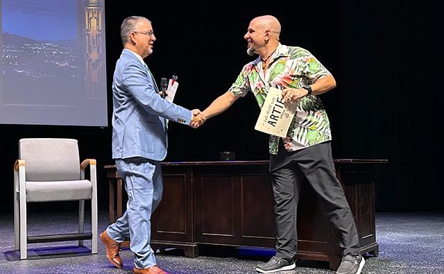 Dr. Eric Leshinskie and Dr. Michael Dzbenski shake hands